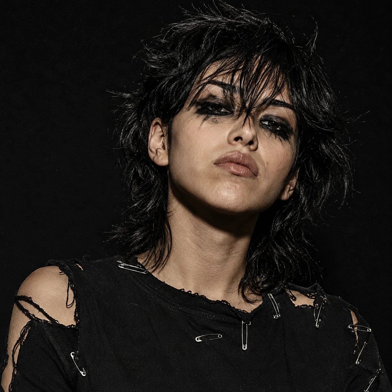Grunge black pfp with torn fabric, safety pins, and smudged eyeliner for a rebellious punk TikTok and Discord avatar