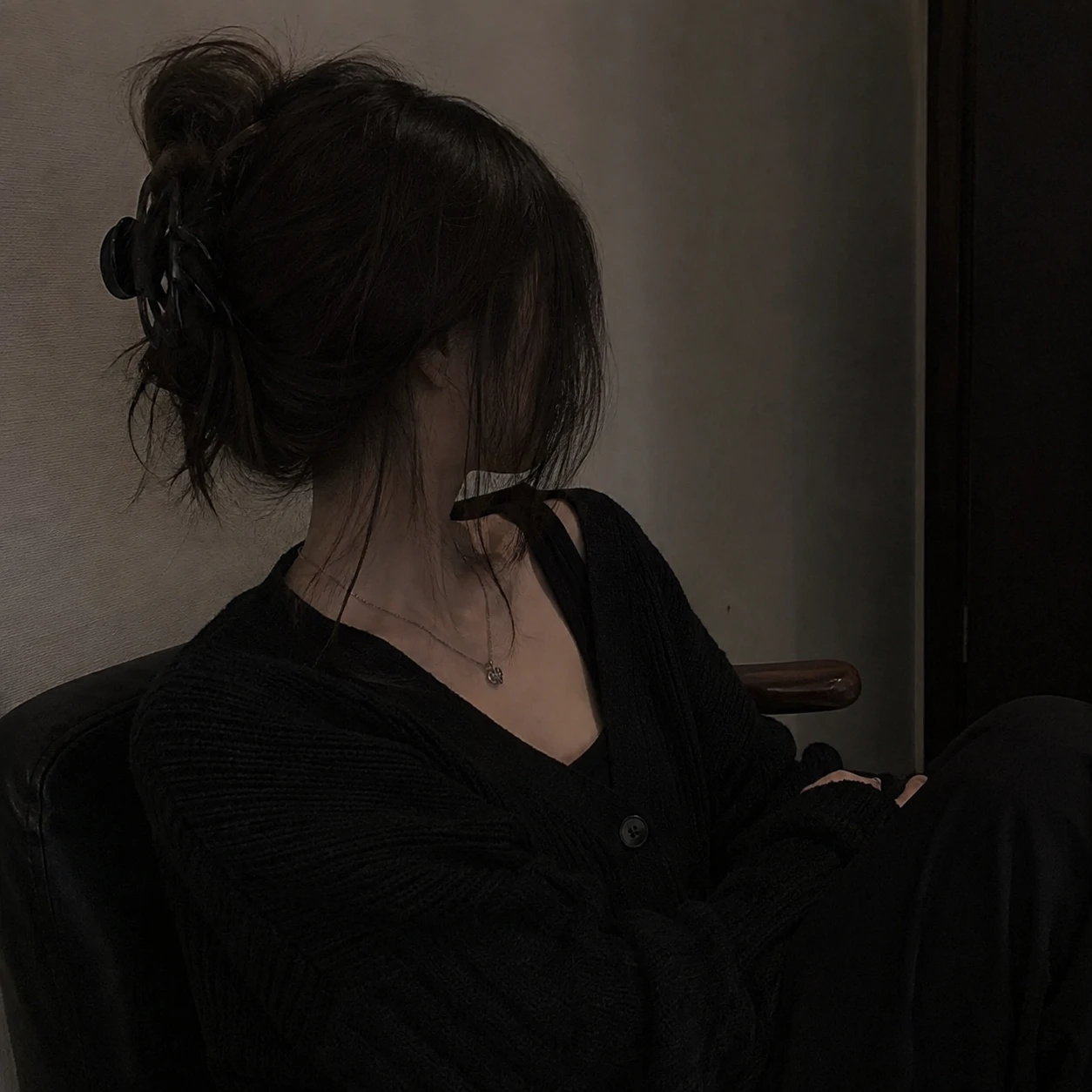 Side-angle girl portrait in black cardigan for unknown girl pfp.