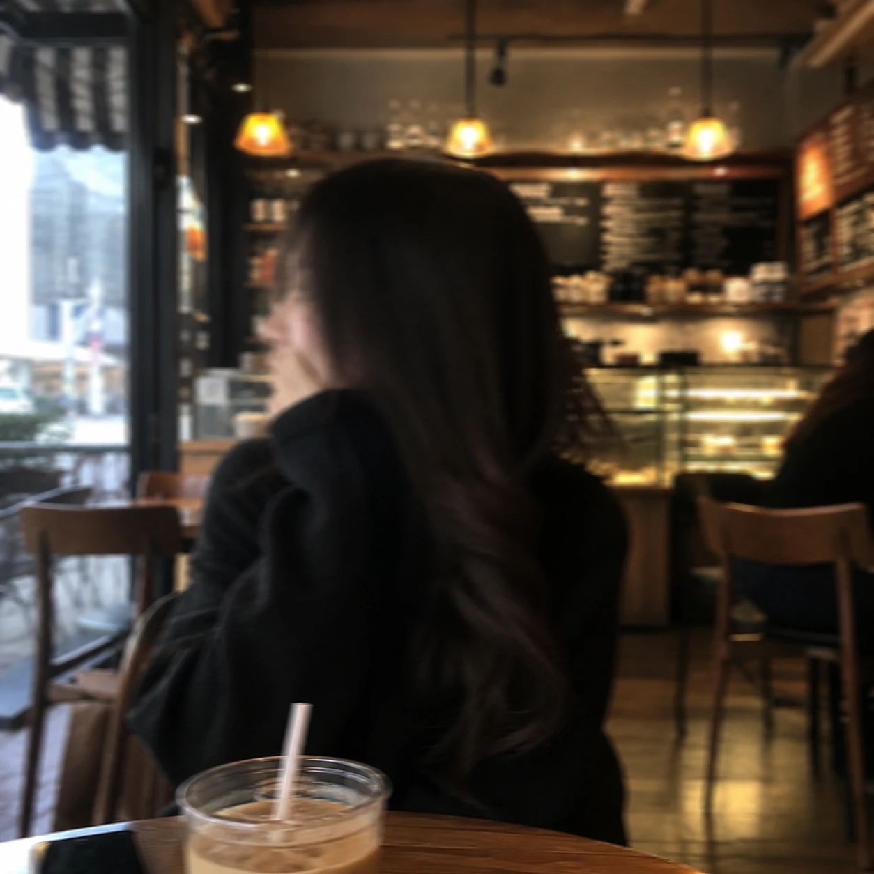 Blurred girl portrait in coffee shop for unknown girl pfp use.