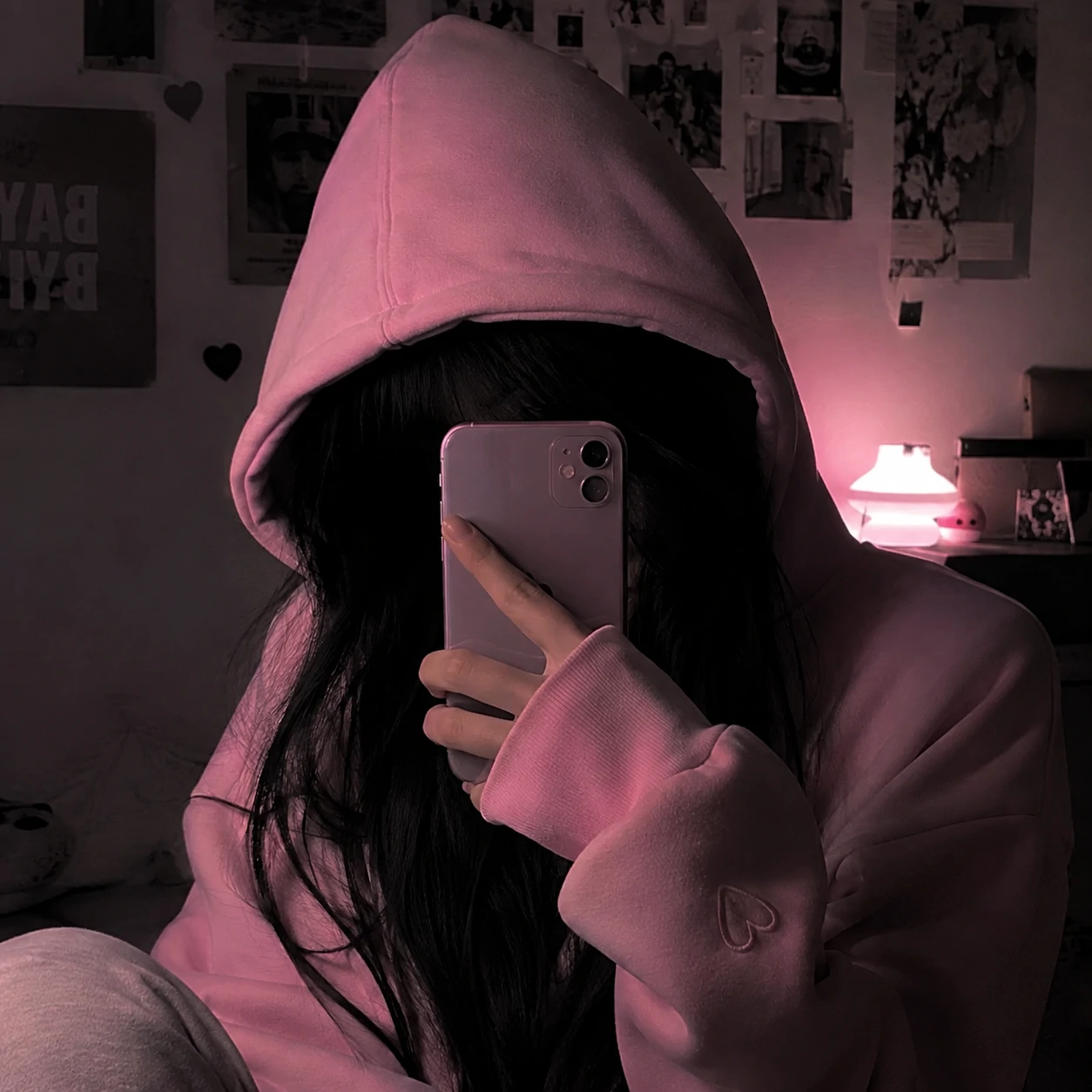 Hidden-face girl in pink hoodie for a cute unknown girl pfp.